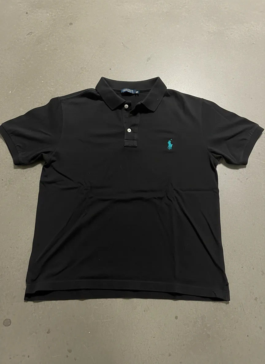 Polished studio-style photo of a navy polo shirt